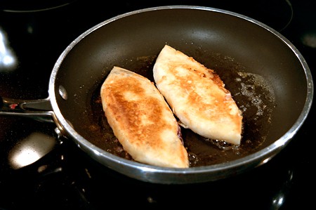 Quesadillas turned to cook on the second side.