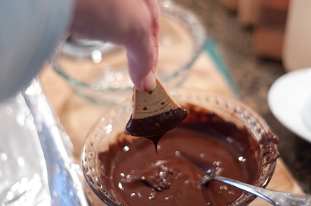 Dipping cookies in melted chocolate