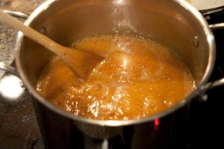 Syrup boiling in a saucepan.