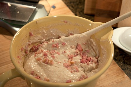 Folding minced ham into the waffle batter.