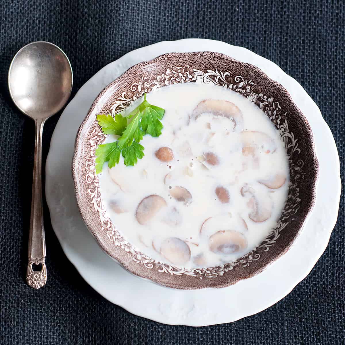 A serving of Cremini Mushroom Soup in a vintage serving dish.