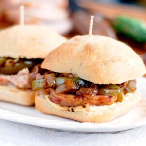 Finished roasted pork tenderloin sandwich on a serving plate.