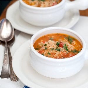 Spanish Rice and Chicken Soup - a lovely version of chicken soup flavored with garlic, cilantro, tomatoes, and taco seasoning. https://www.lanascooking.com/spanish-rice-chicken-soup/