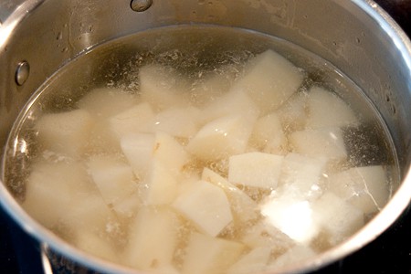 Potatoes cooking in a saucepan.