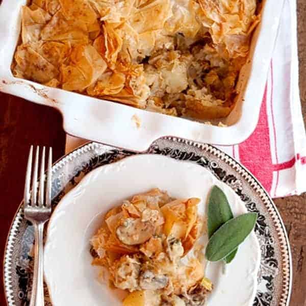 Chicken, Leek, and Mushroom Pie - a lovely, savory pie with a chicken, leek, mushroom and potato filling. A crispy phyllo topping makes the dish lighter. https://www.lanascooking.com/chicken-leek-mushroom-pie