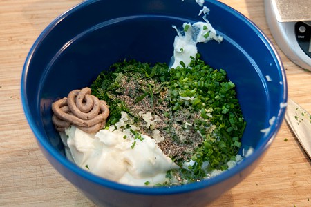 All dressing ingredients in a mixing bowl.