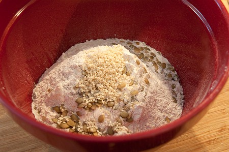 Sifted flour and seeds in a large mixing bowl