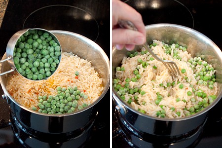 Stirring frozen peas into hot rice in a saucepan.