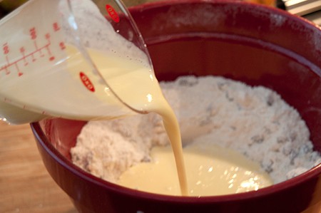 Adding egg and buttermilk to mixture.