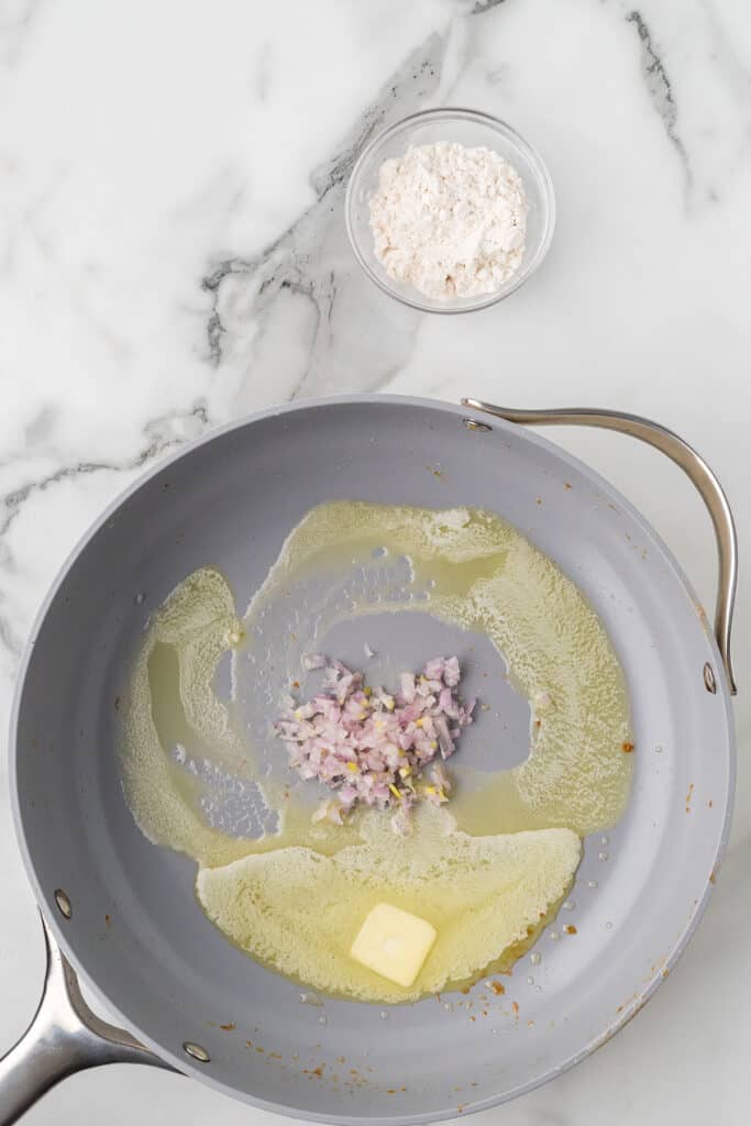 Shallots added to the frying pan.