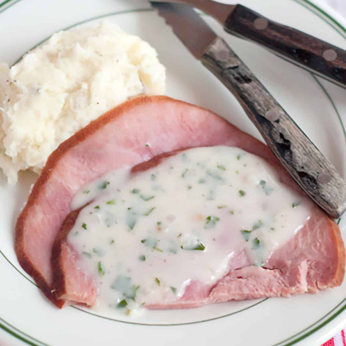 Ham with Creamy Herb Sauce - fully-cooked ham slices warmed and served with a traditional Irish creamy herb sauce. Great choice for your Easter menu. https://www.lanascooking.com/ham-creamy-herb-sauce/