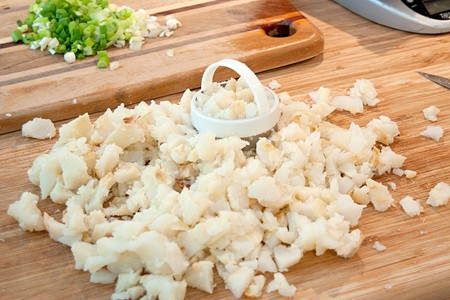 Chopped potatoes on a cutting board.