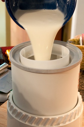 Pouring cream mixture into an ice cream maker.