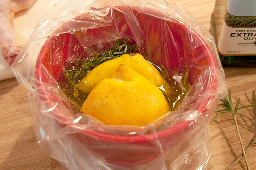 Marinade ingredients in a plastic bag suspended in a bowl.