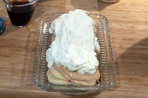 Whipped cream spread over the yogurt layer.