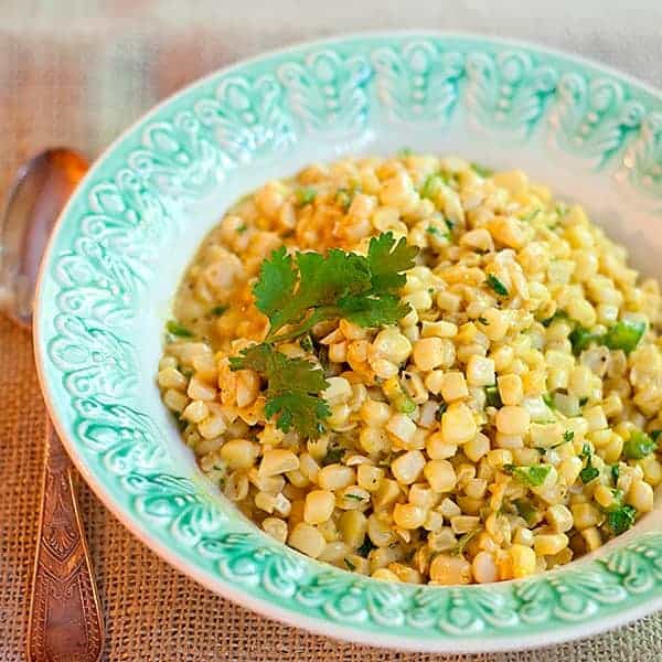 This recipe for Curried Corn combines fresh corn kernels with butter, cream, curry, and cilantro in an old, traditional deep south dish. Great for cookouts or dinner parties. https://www.lanascooking.com/curried-corn/