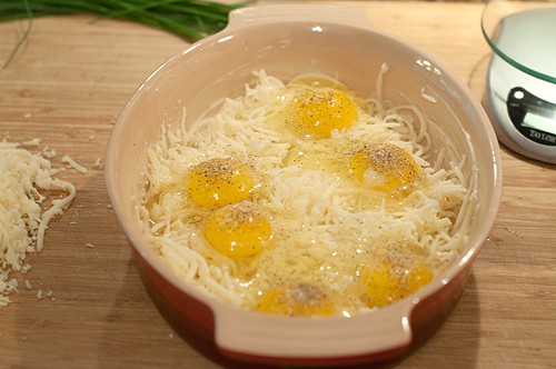 Crack eggs over cheese for Alpine Eggs