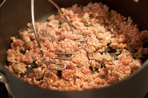 Cooking Italian sausage in a skillet.