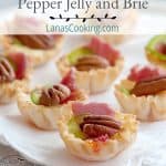 Phyllo Cups with Pepper Jelly and Brie - delicate phyllo pastry filled with pepper jelly and brie, baked and topped with pecans, country ham, and jalapeno. https://www.lanascooking.com/phyllo-cups-pepper-jelly-brie/