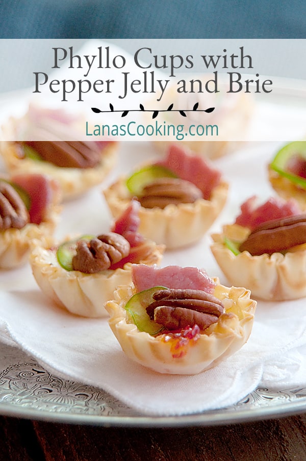 Phyllo Cups with Pepper Jelly and Brie - delicate phyllo pastry filled with pepper jelly and brie, baked and topped with pecans, country ham, and jalapeno. https://www.lanascooking.com/phyllo-cups-pepper-jelly-brie/