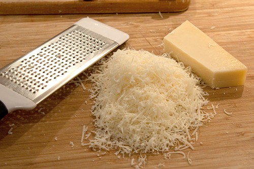 Grated Parmesan cheese on a board.