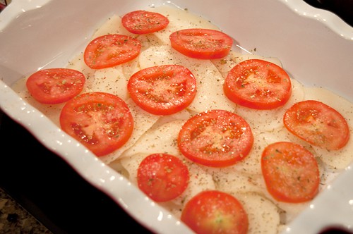 Half the tomato slices layered over the potato slices.