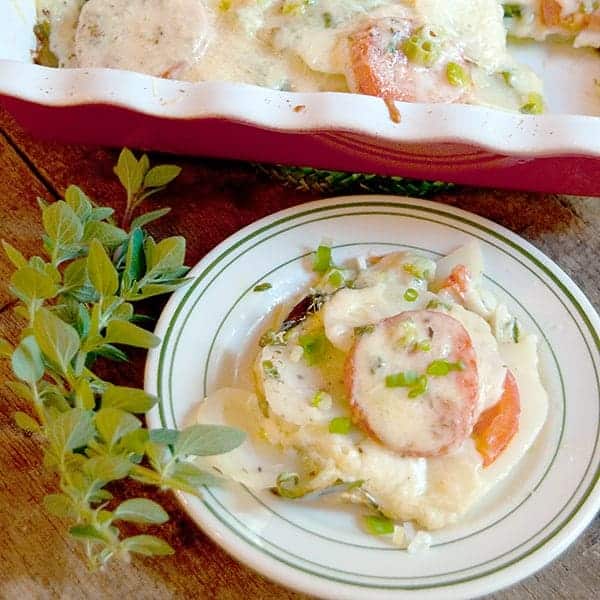 Potato Spinach and Tomato Gratin - a delicious, cheesy gratin made with sliced potatoes, fresh spinach, and tomatoes. Great weeknight side dish. https://www.lanascooking.com/potato-spinach-tomato-gratin/