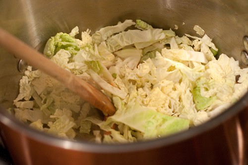 Cabbage added to the soup pot.