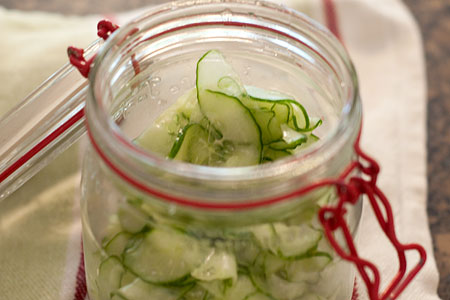 Cucumber slices packed into a glass jar.