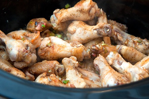 Wings and sauce in a slow cooker.