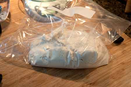 Dough resting in a plastic bag.