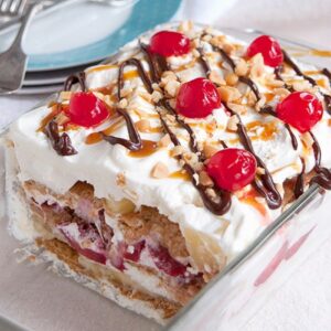 Banana Split Icebox Cake - an old fashioned dessert with layers of whipped cream, banana, strawberries, and pineapple. https://www.lanascooking.com/banana-split-icebox-cake