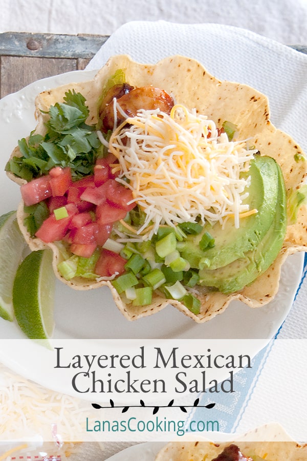 Layered Mexican Chicken Salad - a great main dish lunch or dinner salad featuring couscous and seasoned chicken with cheese, salsa, and cilantro. https://www.lanascooking.com/layered-mexican-chicken-salad/