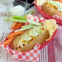 These Buffalo Chicken Dogs make an easy and quick weeknight dinner. Brats topped with purchased Buffalo style chicken topped with blue cheese and celery. https://www.lanascooking.com/buffalo-chicken-dogs/