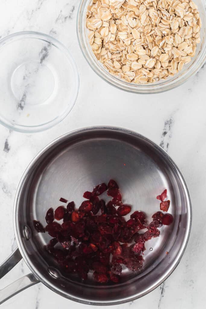 Dried cranberries and water in a saucepan.