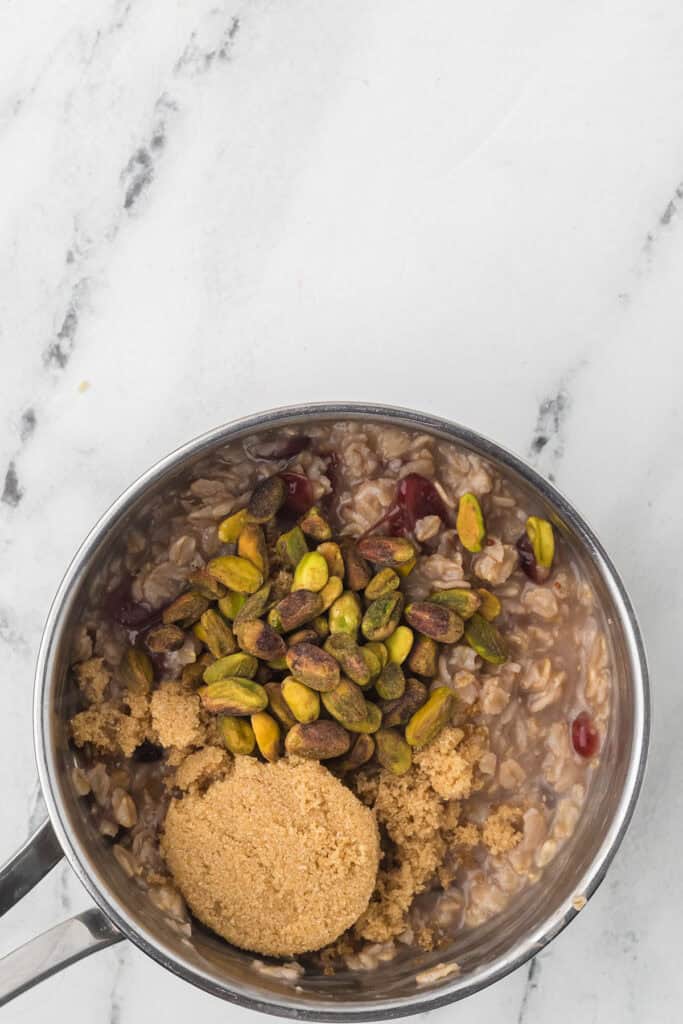 Brown sugar and pistachios being added to the mixture.