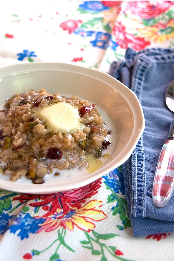 A serving of cranberry pistachio oatmeal in a white bowl.