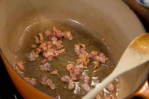 Bacon cooking in a large pot.