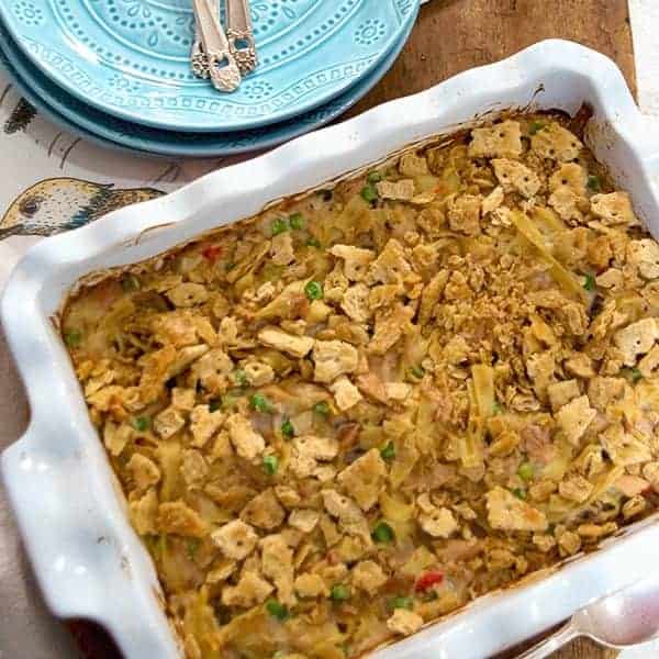 Tuna Noodle Casserole - a classic combination of tuna, peas, and pimiento with egg noodles and sour cream. A family favorite! https://www.lanascooking.com/tuna-noodle-casserole/