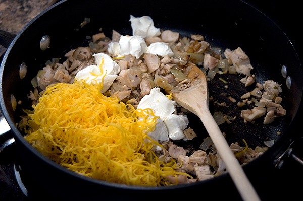 Adding sour cream and cheese to filling.