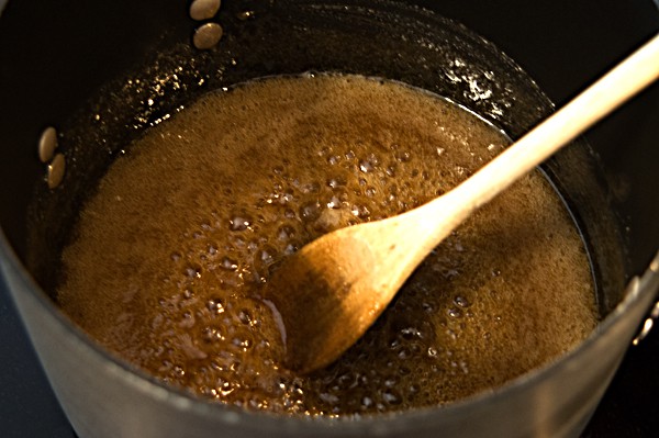 Cooking sugar and syrup in a saucepan.