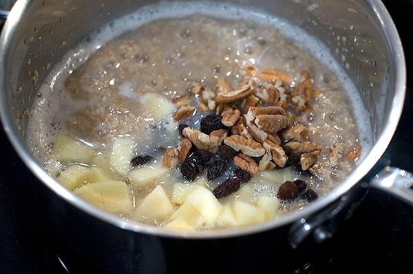 Bring the water and salt to a boil in a medium saucepan over high heat. Whisk in the oatmeal. Add the apple, raisins, pecans, and cinnamon. Stir well. Reduce the heat to a simmer and cook 5-6 minutes or until the water is mostly absorbed and the oats are tender. Serve topped with brown sugar and cream.