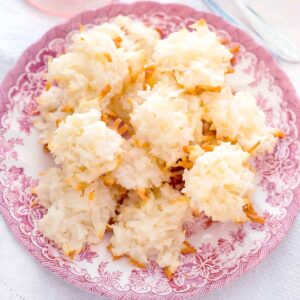Coconut macaroons on a pink and white serving plate.