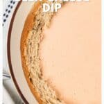 A bread bowl filled with creamy beer cheese dip, viewed from above. Text reads: Beer Cheese Dip.