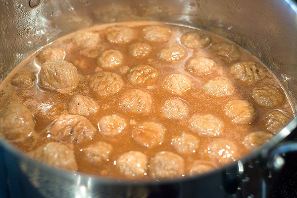 Frozen meatballs added to sauce.