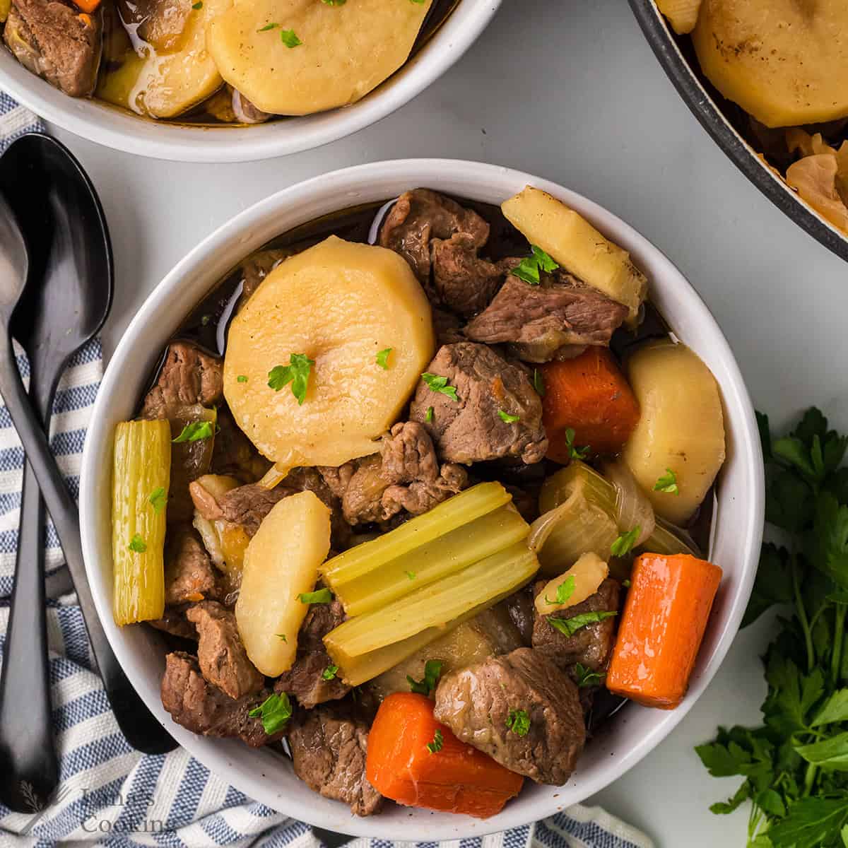 A serving if Irish Stew in a white bowl.