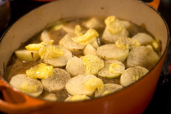 Potatoes and butter added to the top of the stew.