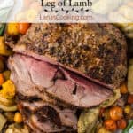 Finished leg of lamb on a bed of vegetables.
