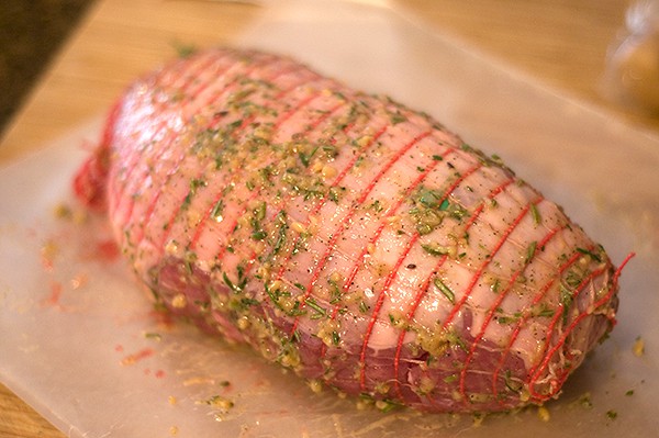 Leg of lamb with seasonings and oil applied.