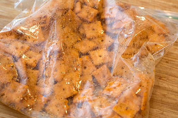 Crackers added to a bag with spices and butter.